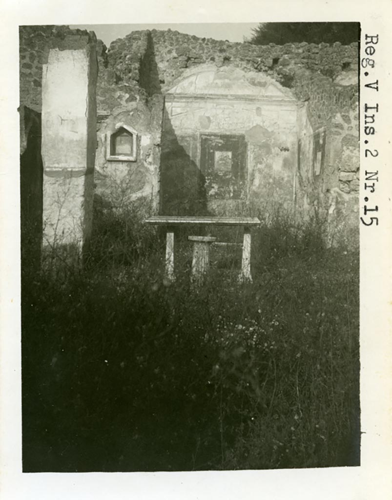 V.2.15 Pompeii. Pre-1937-1939 Looking north across peristyle towards niche, and doorway to room 8, exedra.
The north wall of the exedra is still seen with painted decoration.
Photo courtesy of American Academy in Rome, Photographic Archive. Warsher collection no. 480.