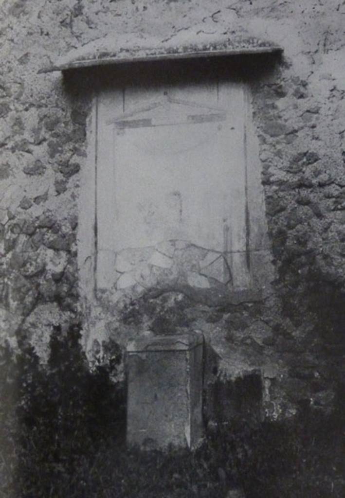 V.2.15 Pompeii. Old undated photograph. Garden 11c. North wall. Lararium.
The Notizie degli Scavi records a panel of white stucco.
On this is painted an aedicula, which Boyce says is painted in blue, yellow, dark red and green.
Within the aedicula is a painting of Giove (Jupiter) seated on a throne.
Underneath is a masonry altar covered with white plaster. 
See Notizie degli Scavi di Antichità, 1894, p. 439.
See Boyce G. K., 1937. Corpus of the Lararia of Pompeii. Rome: MAAR 14.  (96, p.35, Pl 39,3).
