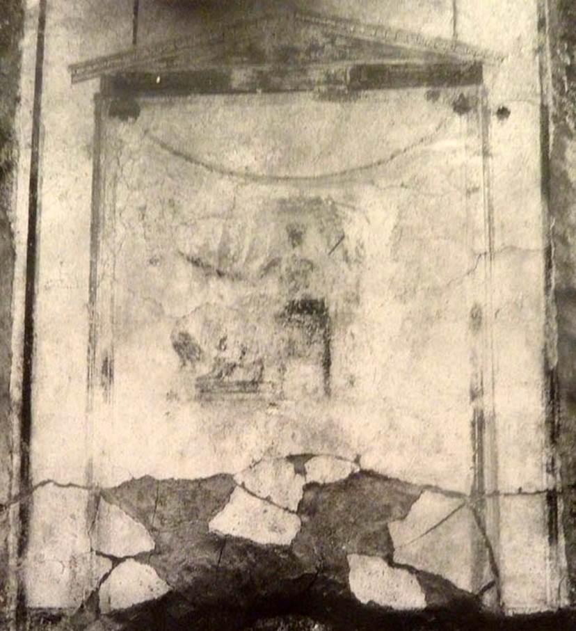 V.2.15 Pompeii. Old undated photograph. North wall of peristyle garden 11c. Remains of central painting in lararium.
Giove (Jupiter) sits on a throne, his lower body covered with a green robe. 
The sceptre is in the left hand, leaning on the arm of the throne. 
The lightning bolt is in his outstretched right hand and the eagle at his feet. 
See Notizie degli Scavi di Antichità, 1894, p. 439.