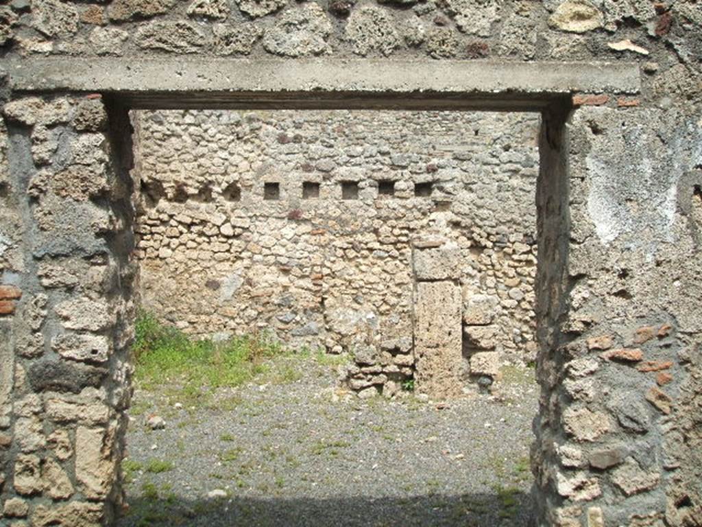 V.2.f  Pompeii. May 2005. Entrance, looking east. According to NdS, the atrium was devoid of an impluvium, but to the right of where one entered was a small hearth. Above the hearth was a semicircular niche and a short distance away, in the south-west corner of the atrium, was a latrine which would have been protected by a lean-to roof. See Notizie degli Scavi, 1896, (p.436. See Mau in BdI, VIII, 1893, (p.7-9)
According to Boyce, just to the right of the entrance against the west wall in the atrium stood a low masonry altar. Traces of fire were seen on the top of the altar when it was first excavated. Above the altar was an arched niche in the wall.
When Boyce wrote (1937) he said “the last layer of plain white stucco has fallen from the interior walls, revealing a finer layer beneath it” This was white and decorated with red spots. Not photographed yet, it may not be still there. See Boyce G. K., 1937. Corpus of the Lararia of Pompeii. Rome: MAAR 14. (p.36, 103)
According to Giacobello, the hearth was located near the niche in the south corner of the atrium. On the same west wall, to the left of the Lararium is a second smaller niche, and also a trace of a third niche to the left again. See Giacobello, F., 2008. Larari Pompeiani: Iconografia e culto dei Lari in ambito domestico.  Milano: LED Edizioni. (p.164 with photo).