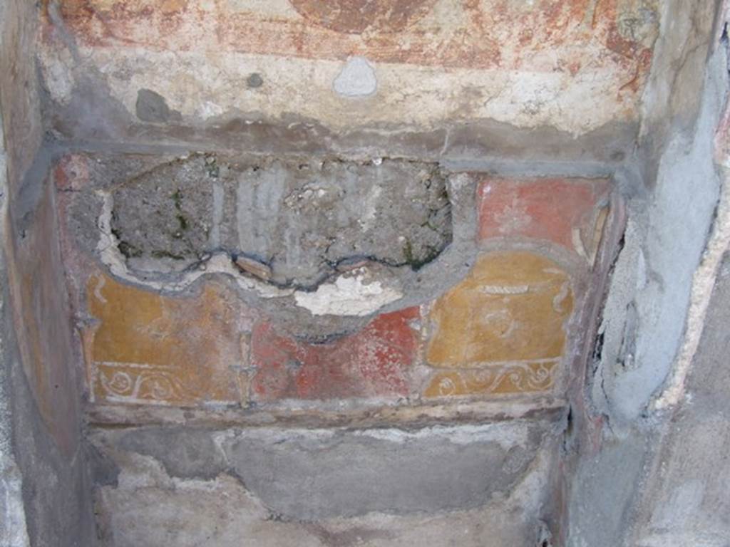 V.3.7 Pompeii. March 2009. West wall of garden area. Lararium lower zone.
The red plaster was painted with an aedicula façade within which stood the painted figure of Ceres.
She was wearing a crown of ears of grain and held a torch in her left hand and a sheaf of grain in her right.
See Boyce G. K., 1937. Corpus of the Lararia of Pompeii. Rome: MAAR 14.  (112, p. 38, Pl 36, 2).