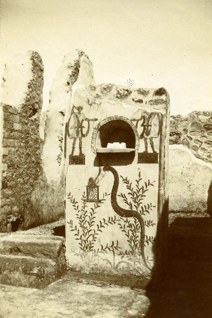 V.3.9 Pompeii. 1903. Household shrine/Lararium on north side of atrium, with niche, two painted Lares, altar and serpent.
Photo by Esther Boise Van Deman (c) American Academy in Rome. VD_Archive_Ph_216.