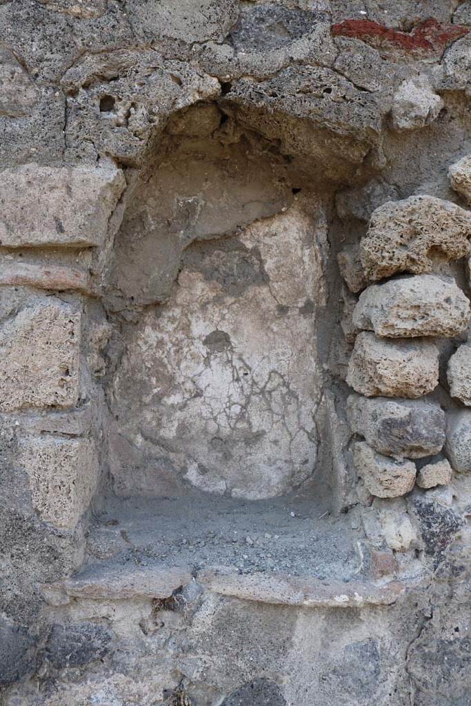 VI.1.14 Pompeii. December 2018. Arched niche in north wall. Photo courtesy of Aude Durand.
According to Boyce –
the walls of the niche (h.0.60, w.0.40, d.0.25, height above the floor 1.10) were coated with red stucco.
See Boyce G. K., 1937. Corpus of the Lararia of Pompeii. Rome: MAAR 14.  (p.42, no.137).