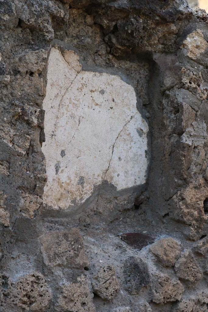 VI.2.1 Pompeii. December 2018. 
Detail of niche in north wall of bar-room. Photo courtesy of Aude Durand.
According to Boyce- 
the large rectangular niche (h.0.65, w.0.50, d.0.18, height above the floor 1.45) had its inside walls painted green.
Fiorelli referred to it as “la nicchia dei Penati”
See Boyce G. K., 1937. Corpus of the Lararia of Pompeii. Rome: MAAR 14. (p44, No.138)