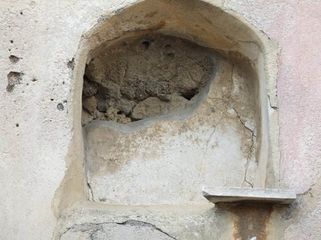 VI.2.24 Pompeii. December 2007. Arched niche in west wall of garden area, with remains of marble shelf. According to Giacobello, this is at quite a considerable height from the floor.  The internal walls of the niche were painted in white. The niche was visible from the vestibule at the entrance.
See Giacobello, F., 2008. Larari Pompeiani: Iconografia e culto dei Lari in ambito domestico.  Milano: LED Edizioni. (p.269)