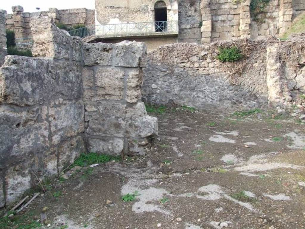VI.9.1 Pompeii. December 2007.  Looking across site of room 14 towards the kitchen, room 13 in north-west corner. Looking north from near entrance.
According to Fiorelli, this area would have been the site of a storeroom and kitchen and latrine.
According to Warscher, the room “b” (our room 14) had a low level and in front of the door into the kitchen, there was a tufa step. 
See Warscher, T, 1938: Codex Topographicus Pompejanus, Regio VI, insula 9: Pars prima, Rome, DAIR.