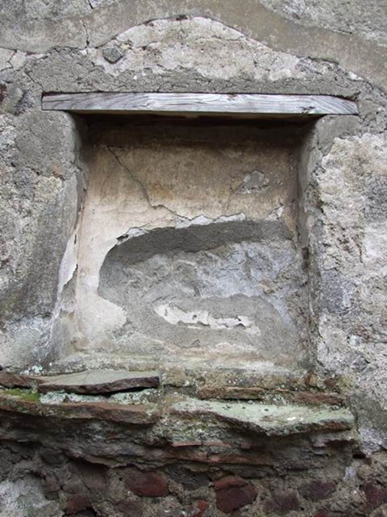 VI.11.9 Pompeii. March 2009. Room 13, square niche on south wall of kitchen.
According to Boyce, in the south wall beside the hearth was a rectangular niche.
On the rear wall was painted the figure of the Genius.
On the floor in front of the niche stood a small masonry altar.
See Boyce G. K., 1937. Corpus of the Lararia of Pompeii. Rome: MAAR 14. (p.51, no.183)
