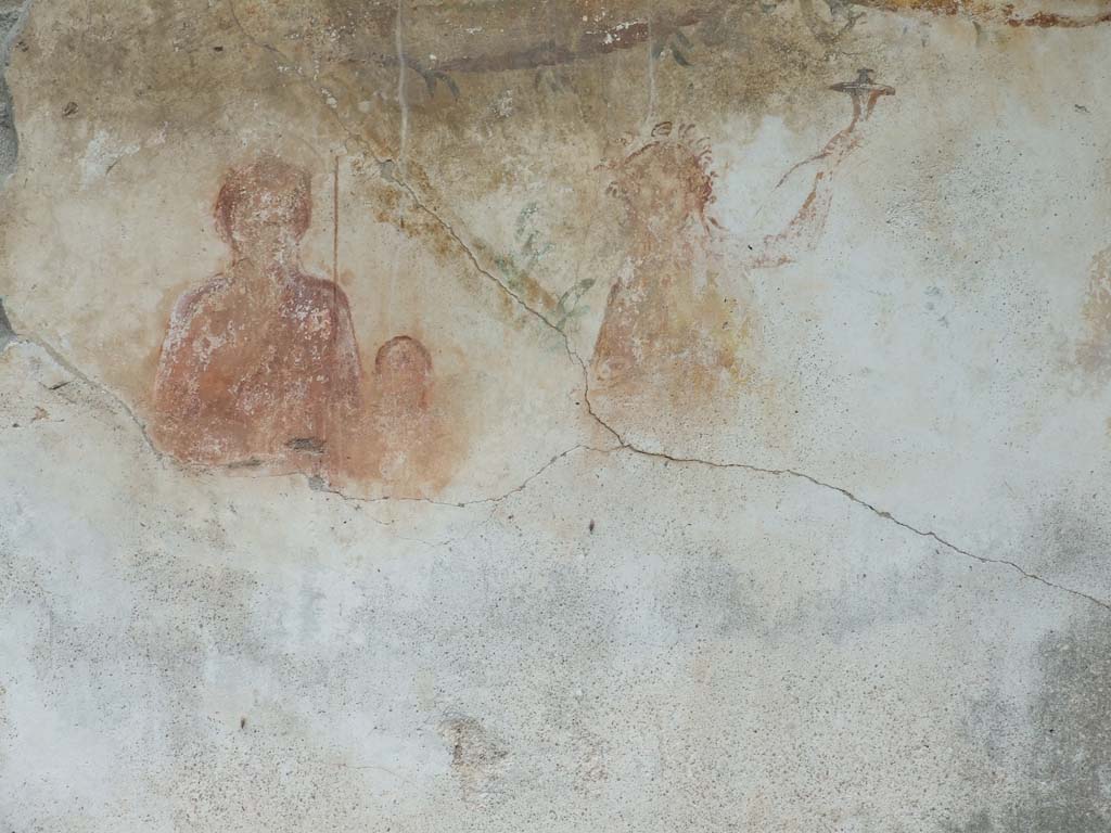 VI.11.9 Pompeii. December 2006. 
Room 16. Household lararium showing Venus Pompeiana, Amor or Eros, and a Lar. A garland can be seen above.