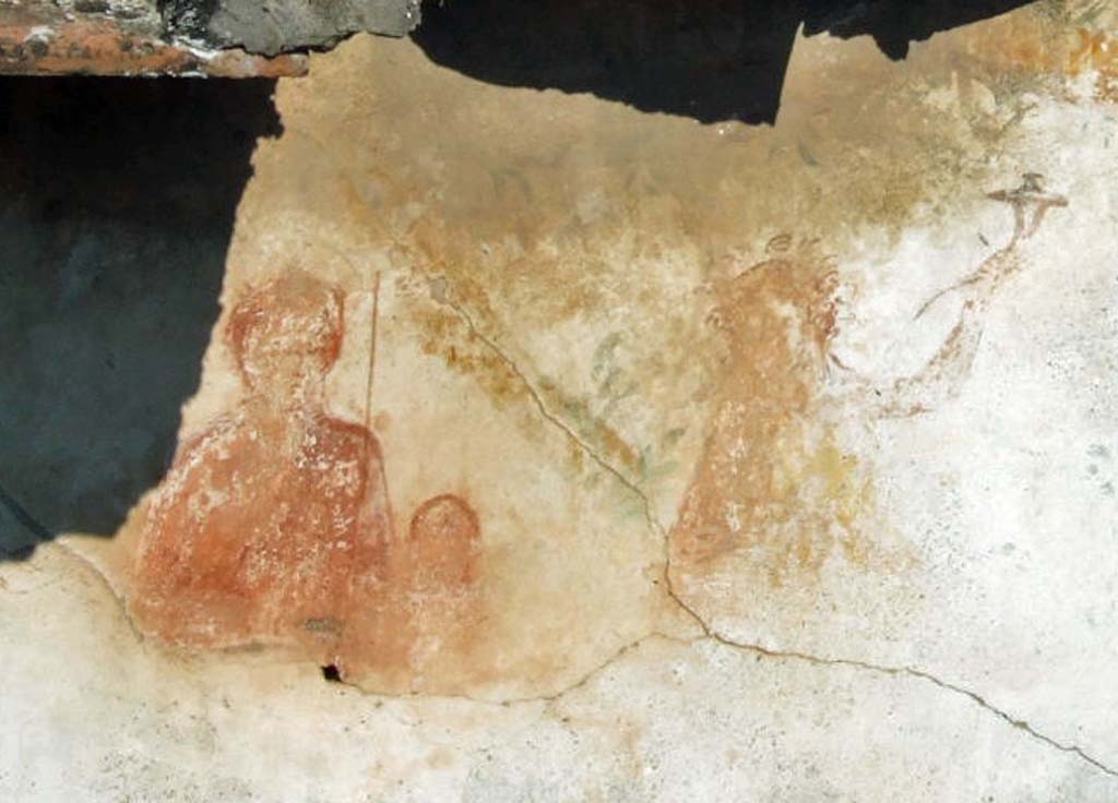 VI.11.9 Pompeii. September 2005. Room 16, detail of figures on lararium.
Household lararium showing Venus Pompeiana and Amor or Eros, and to the right a Lar with a cornucopia.
See Boyce G. K., 1937. Corpus of the Lararia of Pompeii. Rome: MAAR 14. (p.51, No.185, Pl.21, 1).