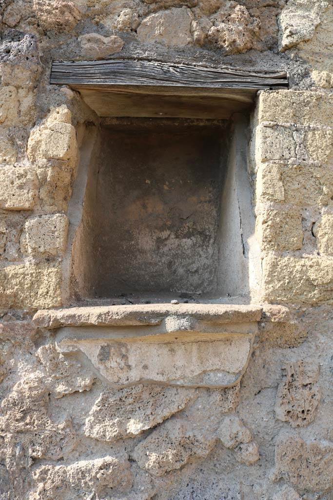VI.14.4 Pompeii. December 2018. Niche in north wall of shop. Photo courtesy of Aude Durand.
According to Boyce - 
in the north wall is a rectangular niche (h.0.45, w.0.35, d.0.30, h. above the floor 1.60), its inside walls coated with white stucco.
Its floor projected as a narrow shelf.
See Boyce G. K., 1937. Corpus of the Lararia of Pompeii. Rome: MAAR 14. (p. 52, no.196)