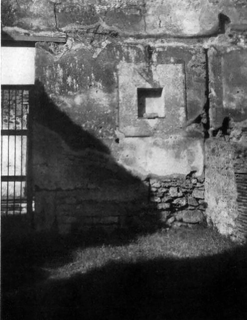 VI.14.18 Pompeii. 1930s photo of lararium niche by Tatiana Warscher.
According to Boyce, in the north wall of the main room (of VI.14.18/19) is a rectangular niche, (h.0.55, w.0.50, d.0.20, h. above the floor 2.10).
It is set in a section of the wall coated with a special panel (h.1.40 w.1.32) of white stucco bordered with red stripes.
The inside walls are coated with the same white stucco.
The floor of the niche projects slightly from the surface of the wall.
In the centre of it is set a masonry block (0.26 by 0.20, h.0.08) to serve either as a base for a statuette or as an altar.
See Boyce G. K., 1937. Corpus of the Lararia of Pompeii. Rome: MAAR 14. (p.52, no.199, with Pl.1, 2)