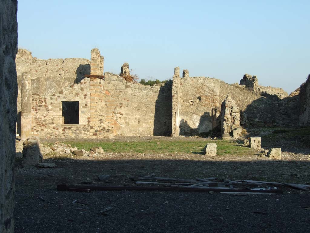 VI.14.38 Pompeii. December 2007. Site of tablinum, and peristyle, looking east to rear rooms.
Jashemski reported that the middle panel of the right (south) wall of the tablinum, instead of having the usual large painting, was plain yellow and contained a small garden scene.
This was reported but not described by Mau.
The left (north) wall was almost completely destroyed at the time of the eruption.
See Jashemski, W. F., 1993. The Gardens of Pompeii, Volume II: Appendices. New York: Caratzas. (p.398, with ref: Mau, BdI (1878), p.115)
According to Jashemski, the peristyle garden at the rear of the tablinum would have been visible from the entrance.
The tablinum would have been completely open on both its east and west ends.
The garden was enclosed on the north, west and south sides by a portico, supported at the time of the eruption by nine columns.
There was a cistern opening without a puteal on both the north and south sides between the two west columns.
In the garden were two marble table supports, and a monopodium without the basin which it probably supported.
In the south-west corner of the peristyle were the ruins of an arched niche.
See Jashemski, W. F., 1993. The Gardens of Pompeii, Volume II: Appendices. New York: Caratzas. (p.150-51)
According to Boyce, in the south-west corner of the peristyle were the ruins of an arched niche, with heavy projecting floor.
See Boyce G. K., 1937. Corpus of the Lararia of Pompeii. Rome: MAAR 14. (p.53, no.205) 
See Giacobello, F., 2008. Larari Pompeiani: Iconografia e culto dei Lari in ambito domestico. Milano: LED Edizioni. (p.275)