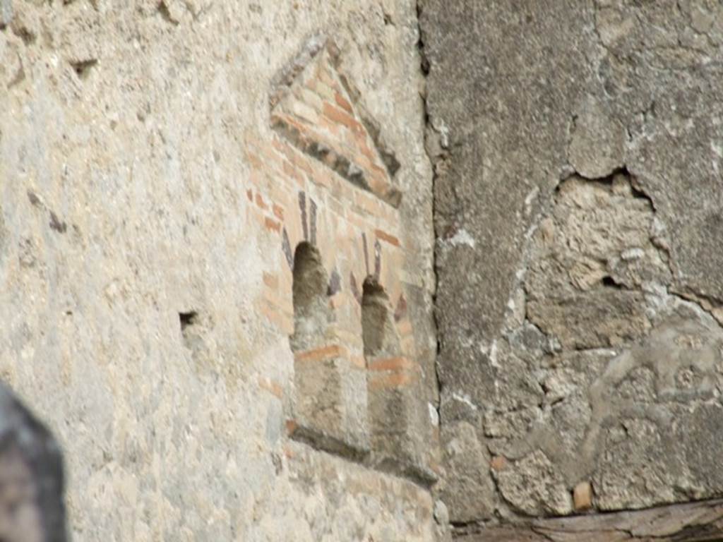 VI.14.40 Pompeii. December 2007. Double niche on north wall of atrium.  
According to Boyce, at the extreme east end of the north wall of the atrium, are two vaulted niches, side by side and 3.22m above the floor.
Above them both is a single pediment formed of projecting tiles.
See Boyce G. K., 1937. Corpus of the Lararia of Pompeii. Rome: MAAR 14. (p. 54, no.207, with Pl.4, 6).