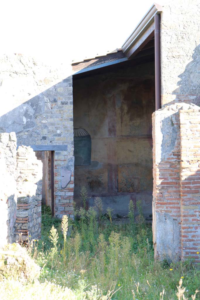 VII.2.25 Pompeii. December 2018. 
Looking east across garden area towards niche in east wall. Photo courtesy of Aude Durand.
According to Boyce –
in the east wall of the oecus opening off the east side of the viridarium is an arched niche (h.1.18, w.0.87, d.0.30, h. above floor 1.52) the inside walls of the niche were painted green and blue and the ceiling was a shell of stucco.
The wall around the niche was painted with a garden decoration of plants, flowers and birds.
See Boyce G. K., 1937. Corpus of the Lararia of Pompeii. Rome: MAAR 14. (p.63, no. 254) 
Breton said that there were five bronze Penates discovered here, but these were not mentioned elsewhere. 
See Breton, Ernest. 1870. Pompeia, Guide de visite a Pompei, 3rd ed. Paris, Guerin. Breton, (p. 412)
See Bragantini, de Vos, Badoni, 1986. Pitture e Pavimenti di Pompei, Parte 3. Rome: ICCD. (p.80)
See Giacobello, F., 2008. Larari Pompeiani: Iconografia e culto dei Lari in ambito domestico. Milano: LED Edizioni, (p.279 no.V63)