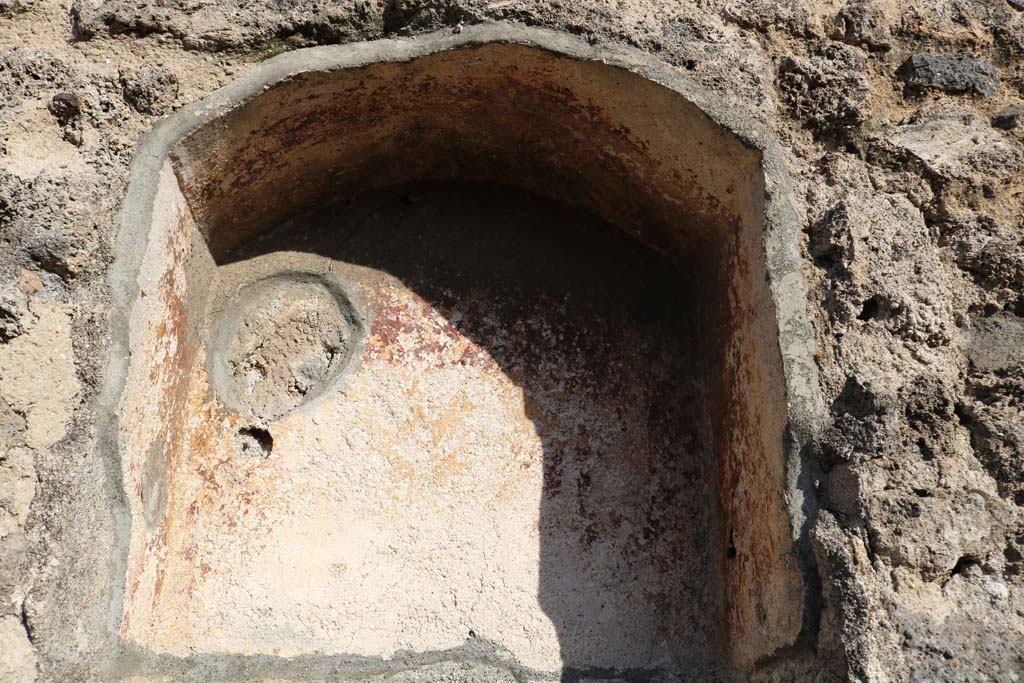 VII.3.10 Pompeii. December 2018. Niche in east wall. Photo courtesy of Aude Durand.
According to Boyce, the inside walls of this arched niche (h.0.55, w.0.45, d.0.27, h. above floor 1.50) were coated in red stucco.
Fiorelli called it la nicchia dei Penati.
See Boyce G. K., 1937. Corpus of the Lararia of Pompeii. Rome: MAAR 14. (p. 64, no.262) 
See Pappalardo, U., 2001. La Descrizione di Pompei per Giuseppe Fiorelli (1875). Napoli: Massa Editore. (p. 86)