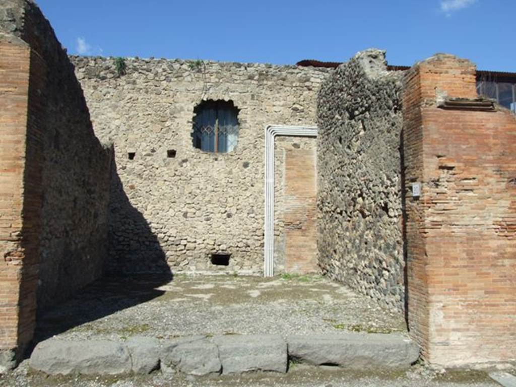 VII.4.20 Pompeii. March 2009. North and east wall of shop room.
Note that the north wall is modern, and has effectively reduced the size of the original large shop-room by about half.
According to Fiorelli, at the rear of this shop-room was a triclinium, preceded by the stairs to the upper rooms, and skirted by a corridor that came into a small courtyard/garden, and where to the left were two small rooms and the main garden area. To the right and covered by a lean-to roof was the kitchen, latrine, cistern and perhaps also a store-room. Painted on the rear north wall of the courtyard, facing the corridor, was the lararium, but nothing remains of it today, other than the drawing by La Volpe and the incision of Museo Borbonico.
See Pappalardo, U., 2001. La Descrizione di Pompei per Giuseppe Fiorelli (1875). Napoli: Massa Editore. (p.90).
