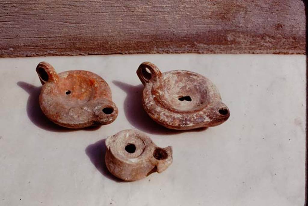 M.1A. Pompeii. 1975. Photo by Stanley A. Jashemski.   (Where from originally ? These are the same lamps as below). 
Source: The Wilhelmina and Stanley A. Jashemski archive in the University of Maryland Library, Special Collections (See collection page) and made available under the Creative Commons Attribution-Non Commercial License v.4. See Licence and use details.
J75f0577