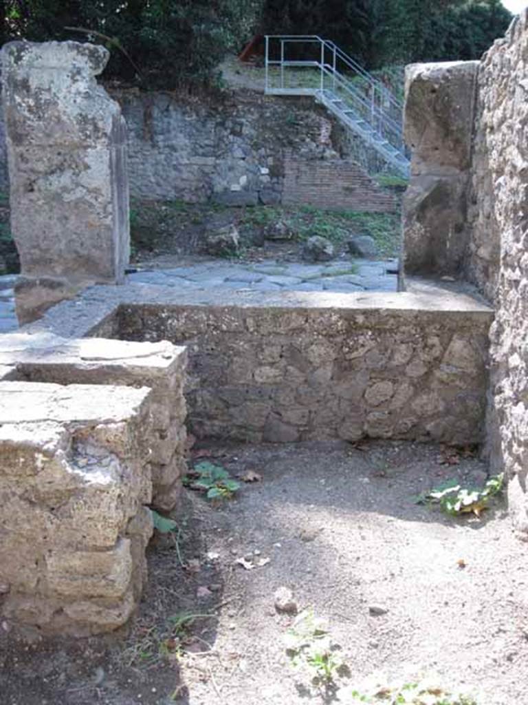I.1.1 Pompeii. September 2010. Looking west across rear of counter towards Via Stabiana. Photo courtesy of Drew Baker.