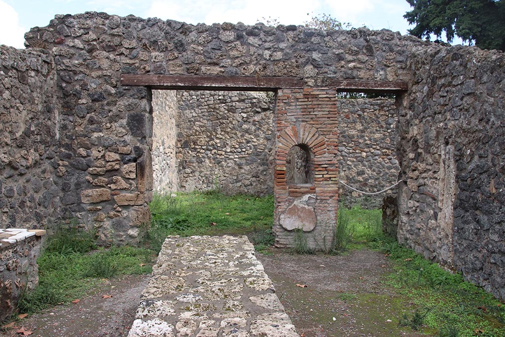 I.1.2 Pompeii, October 2024. 
Looking east across bar/selling room with counters. At the rear are entrances to two rear rooms. Photo courtesy of Klaus Heese.