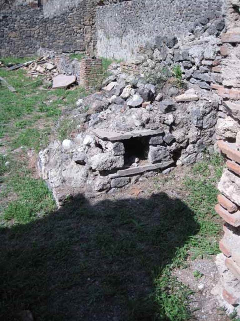 I.1.3 Pompeii. September 2010. Looking north across yard area from doorway to kitchen, with remains of the oven. Photo courtesy of Drew Baker.