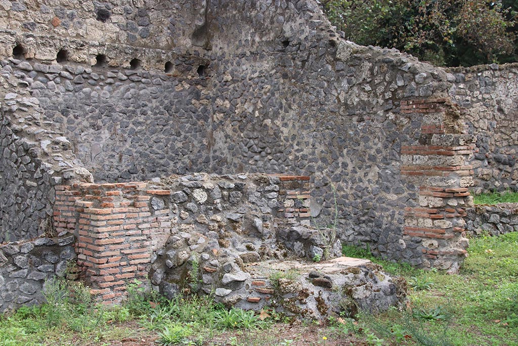 .1.3 Pompeii, October 2024. Looking towards east wall, south-east corner and south wall of kitchen “f”. 
On the right is the doorway into area “g”, the second stables area behind I.1.2. Photo courtesy of Klaus Heese.