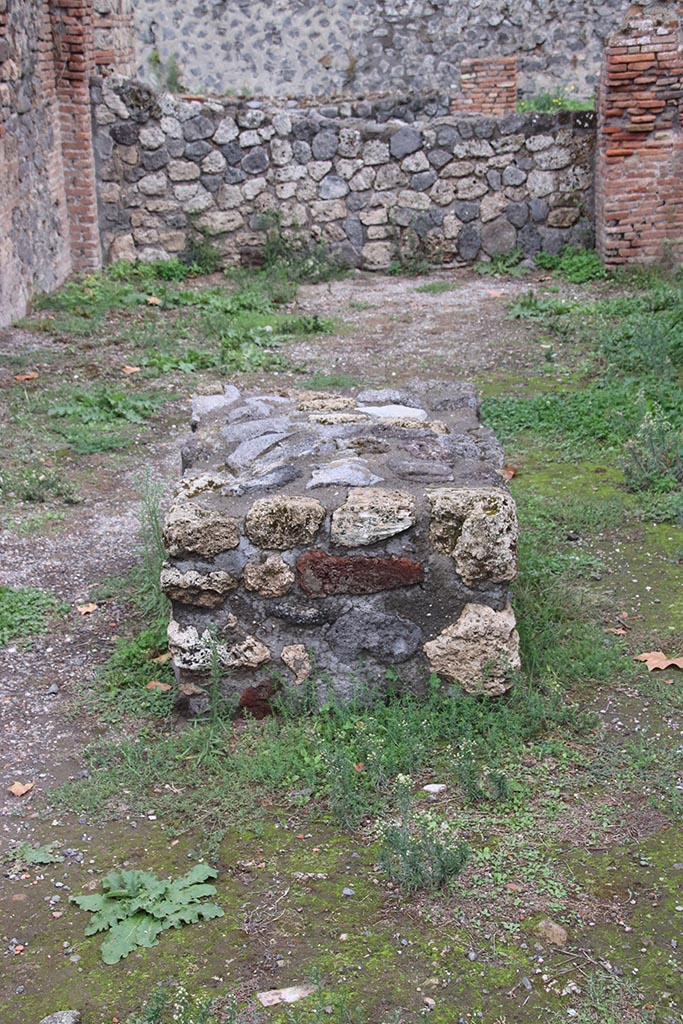 I.1.4 Pompeii. October 2024. 
Looking east towards large masonry bench in the centre of the shop-room. Photo courtesy of Klaus Heese.