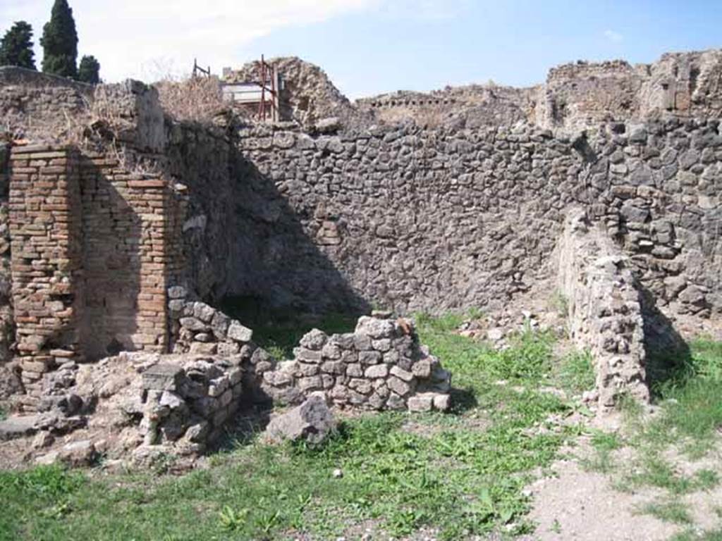 I.1.8 Pompeii. September 2010. Doorway to room on north side of yard, possibly a dormitory. The remains of the steps to upper floor are on the left of the photo. Photo courtesy of Drew Baker.