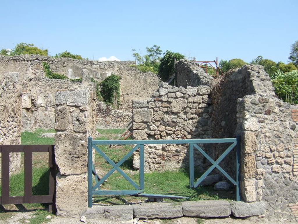 I.2.2 Pompeii. May 2005. 
Looking east into shop room with a rear door into the atrium of the house at I.2.3.          
Warscher described this as – “I.2.2 taberna communicante con la casa No.3”.
See Warscher T., 1935. Codex Topographicus Pompeianus: Regio I.2. Rome:DAIR.