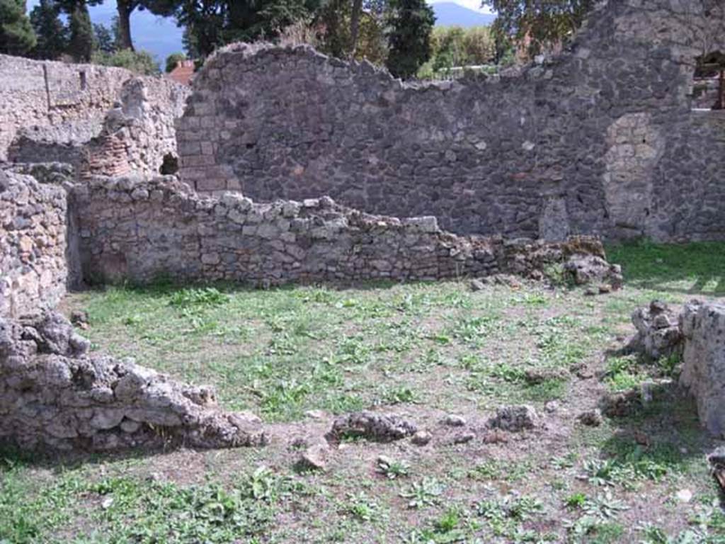 1.2.3 Pompeii. September 2010. Looking south across remains of south wall of triclinium, into tablinum. Photo courtesy of Drew Baker.