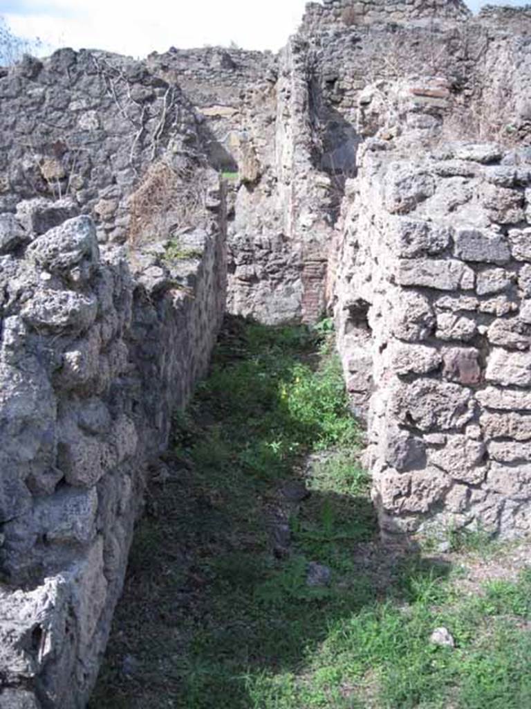 1.2.3 Pompeii. September 2010. Looking north along corridor leading from kitchen. On the right (east) can be seen the stairs to the upper floor.
Photo courtesy of Drew Baker.