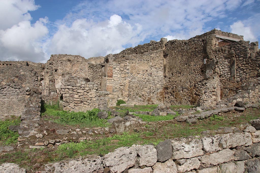 I.2.3 Pompeii. October 2024. 
Looking north towards east wall of garden area, centre right.
On the right is the east wall of two rooms, one a storeroom and one a sacrarium. Photo courtesy of Klaus Heese.