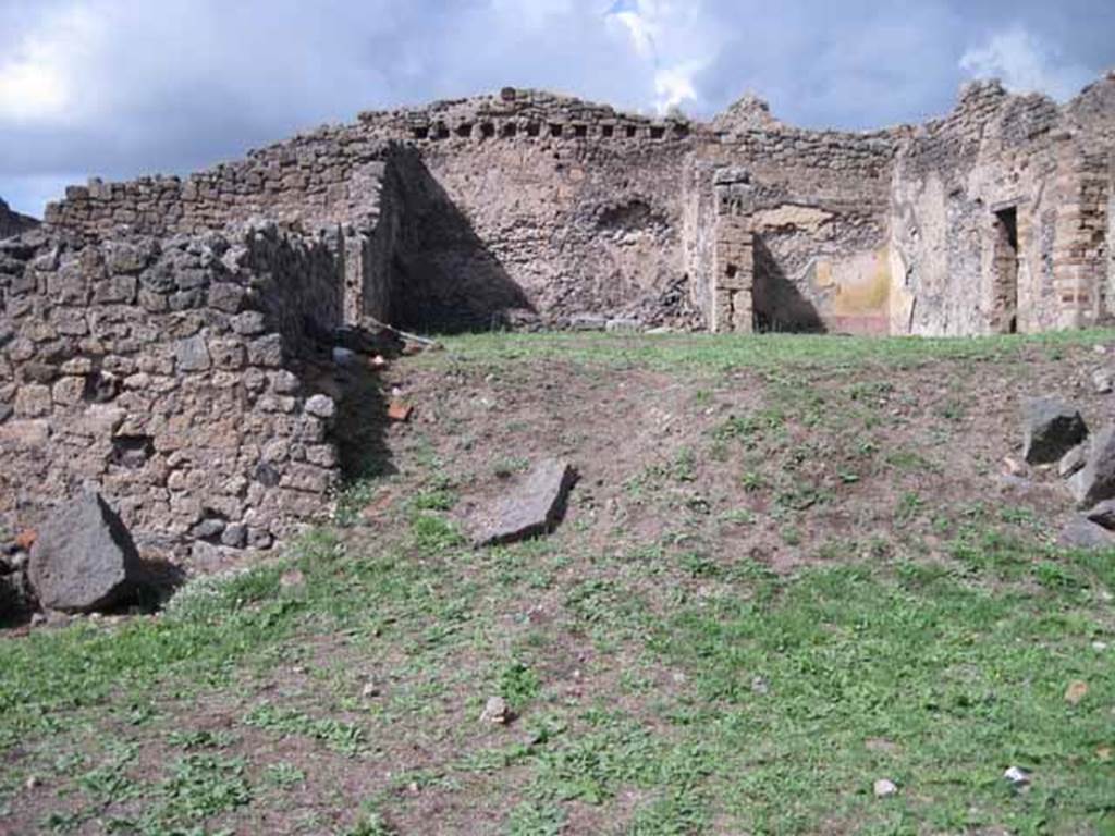 1.2.3 Pompeii. September 2010.  Looking north towards remains of middle part of north wall of atrium. The north wall of house at I.2.6 is visible at the rear. Photo courtesy of Drew Baker.
In this area (bombed in 1943) would have been the site of the two cubicula mentioned by Fiorelli. In one of them, he said, was antique decoration under the more recent restoration. The other contained two paintings, Polyphemus and Galatea and Ariadne abandoned by Theseus.
According to Fiorelli, there was a third painting which had been destroyed. Included on the walls were painted medallions enclosed in circles of wreaths of leaves, which were still visible. In one were Mars and Venus, in another Meleager and Atalanta, and in third was the head of a Bacchante. On the wall to the right was a small hollow covered internally with marble, probably to hold a lantern.
See Pappalardo, U., 2001. La Descrizione di Pompei per Giuseppe Fiorelli (1875). Napoli: Massa Editore. (p.34)
See Garcia y Garcia, L., 2006. Danni di guerra a Pompei. Rome: L’Erma di Bretschneider. (p.38, no.21 for photo of wall with Polyphemus and Galatea).
According to Warscher’s list from Prof.Sogliano, the paintings listed were all from the third cubiculum to the left of the atrium. Head of Bacchante, no. 199 on p.45, 
Polyphemus and Galatea, no. 474 on page 78, Heads of Atalanta and Meleager, no. 507 on page 89, Ariadne abandoned by Theseus, no.534 on page 97, Heads of Mars and Venus, no 605; and a female head (this one nearly all destroyed) no.606, on page 124).
See Warscher T., 1935. Codex Topographicus Pompeianus: Regio I.2. Rome: DAIR (after photo no.12).   
See Sogliano, A., 1879. Le pitture murali campane scoverte negli anni 1867-79. Napoli: (p. 45, 78, 89, 97, 124)