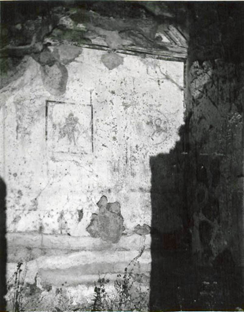 I.2.3 Pompeii. 1935 photo by Tatiana Warscher.
Looking towards north wall of cubiculum, with central painting of Poliphemus and Galatea.
Warscher described this as, by quoting Sogliano - 
“I.2.3 Nel cubicolo (a destra?) erano tre quadretti; ne abbiamo solamente uno con Polifemo e Galatea. L’Arianna abbandonata è distrutta. Si vedono ancora le traccie dei medaglioni, uno coi busti di Marte e Venere. 
She also quoted Mau, from Bull. Inst. 1874, p.202-3 –
“Le tre pareti di detta camera sono divise ciascuna in tre scompartimenti, ne’quali in mezzo a ciascuna parete vi è un piccolo quadro, sui due lati medaglioni con figure visibili sino al petto, circondati da ghirlande. In mezzo al muro di fondo abbiamo un quadro compagno di quello descritto dall’Helbig (no.1052) e spiegato per Polifemo e Galatea. 
Qui Polifemo, nudo sta seduto, tenendo sulla coscia Galatea: si guardano affettuosamente negli occhi. Accante sta un ariete. Nel medaglione a sinistra una donna con capelli biondi e svolazzanti, armata di elmo e lancia, si rivolge a destra verso un uomo imberbe, che come pare le parla nell’orecchio.  Nel madaglione a destra vediamo una donna con capello, turcasso e due lancie; sopra la sua spalla destra è visibile la testa d’un uomo imberbe e armato d’una lancia, che la guarda attentamente e sembra parlare; ella invece guarda dalla parte opposta con aria scontenta, se non m’inganna l’esecuzione trascurata.  A sinistra si scorge come un vaso sopra una base.
In mezzo alla parete destra nel primo piano sta sdraiata Arianna, appoggiandosi sul braccio destro; nel fondo si scorge la nave.  Nel medaglione a sinistra vi è una testa di baccante, e a destra di essa un vaso ed un tirso sopra un base.  In quello a destra si vede una testa muliebre ed un’altra testa più piccola, di cui non si distinguono I dettagli.
See Warscher T., 1935. Codex Topographicus Pompeianus: Regio I.2. (no.6), Rome: DAIR, whose copyright it remains.   
(translation: from Sogliano - “I.2.3 In the cubiculum (on the right?) were three paintings; of them we have only the one with Polyphemus and Galatea. The abandoned Ariadne was destroyed. You could still see the traces of medallions, one with the busts of Mars and Venus”.
from Mau – “The three walls of the room are each divided into three compartments, in the middle of which on each wall was a small picture, on either side of which were medallions with figures, surrounded by garlands.  In the middle of the rear wall we have a companion painting of that described by Helbig (no.1052) and explained as Polyphemus and Galatea. Here was nude Polyphemus, sitting holding onto the thigh of Galatea, looking lovingly into each others eyes.  Nearby was a ram. In the medallion on the left, we could see a flying figure of a woman with blonde hair, armed with helmet and spear, turning to the right towards a beardless man, who seemed to be speaking into her ear. In the medallion on the right, we could see a woman with hair, a quiver and two lances: visible above her right shoulder was the head of a beardless man also armed with a lance, looking attentively at her and seeming to speak; she instead looked towards the opposite side with an unhappy air, if we are not mistaken. On the left, one could see a pot on a base.
In the middle of the right wall in the foreground was Ariadne, lying down leaning on her right arm; in the background you could see the ship.   In the medallion on the left there was the head of a bacchante, and to the right of it a vase and a thyrus on a base.   
On the right you could see a head of a woman and another smaller head, but of these one couldn’t distinguish the details.”