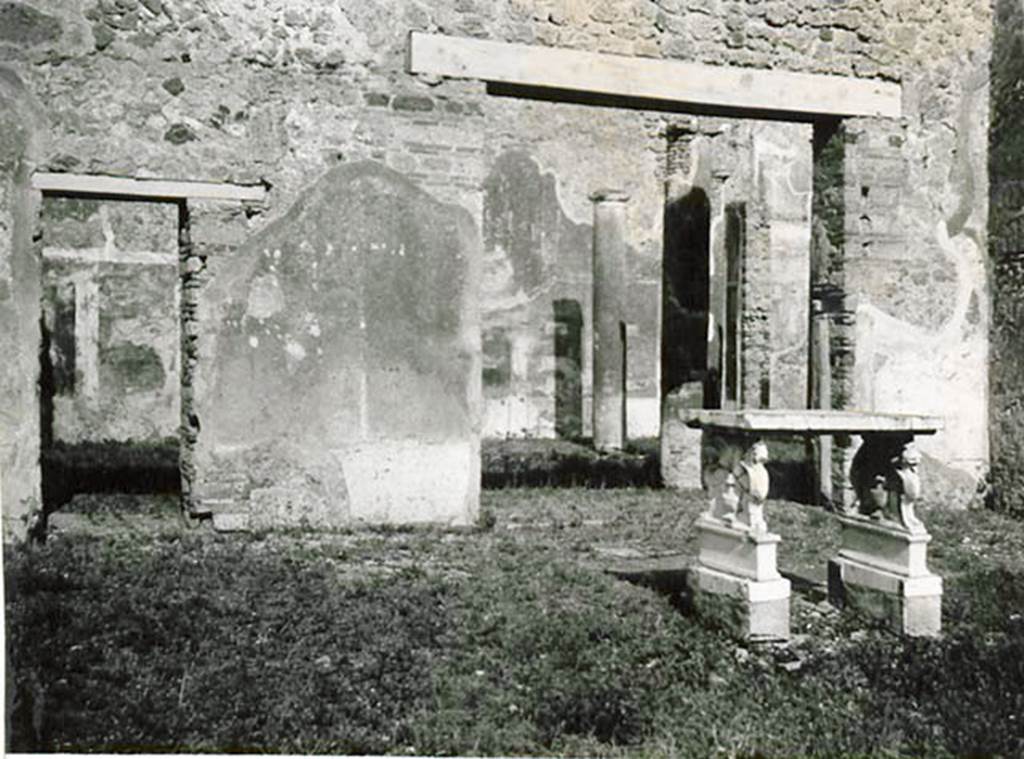 1.2.6 Pompeii. 1935 photo taken by Tatiana Warscher. Looking towards east wall of atrium, with two doorways leading to portico of peristyle. Warscher quoting Mau in BdI, 1874, p.199, described –
I.2.6 “L’atrio toscanico offre poco interesse. Sul lato orientale dell’impluvio sta una tavola di marmo, sorretta da due sostegni su basi murate. I sostegni sono formati ciascuno da due grifi, una con testa di leone, l’altro di cavallo. Sul piano che resta libero fra’grifi in ciascun de’lati esteriori, è rapresentato il vaso con coperchio alto ed appuntato e due ornamenti che hanno la forma di teste d’acquila, in ciascuno dei lati interiore un cornucopia con frutta.”
See Warscher T., 1935. Codex Topographicus Pompeianus: Regio I.2. (no.14), Rome: DAIR, whose copyright it remains.
(translation: the Tuscanic atrium offers little of interest. On the eastern side of the impluvium was a marble table, held up by two supports on brick bases. Each of the supports were formed from two griffins, one with the head of a lion, the other with a horse’s head. 
On the side edge that remained free between the griffins, on each of the exterior sides was represented a vase with a tall lid and two ornaments that have the shape of an eagle heads, in each of the interior sides a cornucopia with fruit.")
According to Bragantini, in the atrium two marble table legs were photographed. The two griffin supports were included, but the two pegasus supports had been transferred.
See Bragantini, de Vos, Badoni, 1981. Pitture e Pavimenti di Pompei, Parte 1. Rome: ICCD. (p.1)