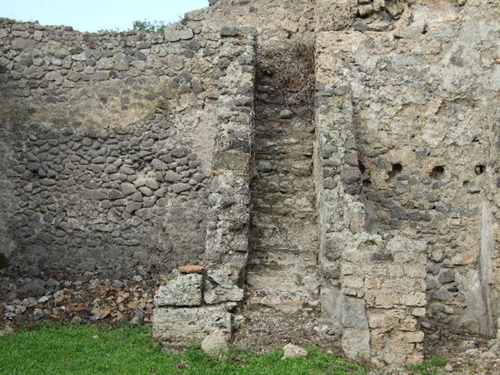 I.2.6 Pompeii. Steps to upper floor and kitchen.
Boyce says that in a small room, perhaps a kitchen on the intermediate floor, reached by stairs on north side of peristyle, was a Lararium.  
Below a small arched niche, a rectangular panel was marked off and within it was painted a single serpent advancing left towards the offerings upon an altar: in the background were plants and across the top were festoons.
See Boyce G. K., 1937. Corpus of the Lararia of Pompeii. Rome: MAAR 14. (p.21 no.5) 
Note: Found in the kitchen located on the first floor was a bronze statuette of Diana with bow and quiver. Giornale degli Scavi, N.S. III, 1874, 58.