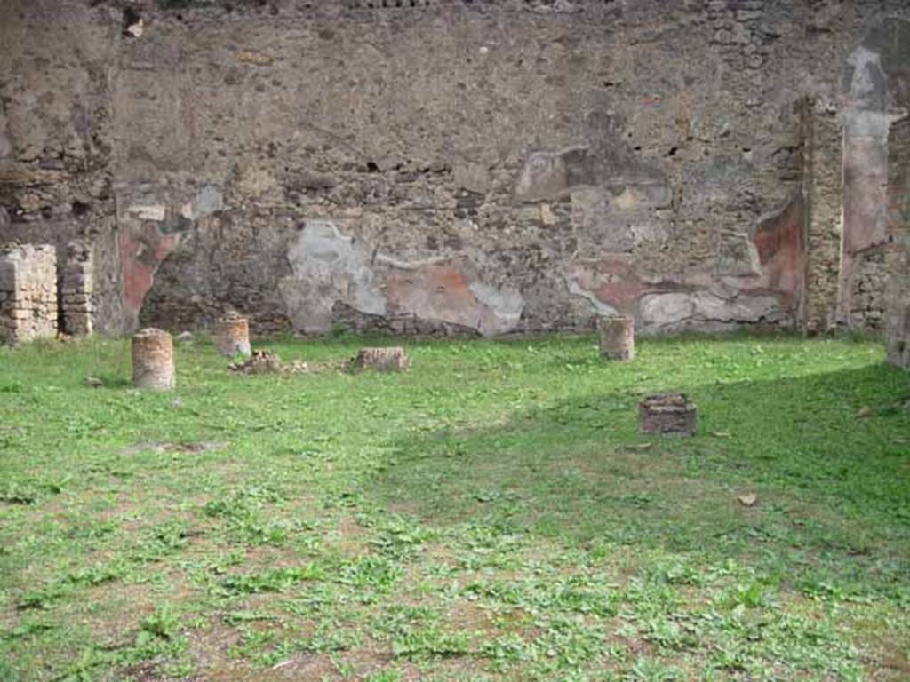 1.2.6 Pompeii. September 2010. East wall of peristyle. Photo courtesy of Drew Baker.
According to Warscher, quoting Mau in BdI, 1874, p.199, she described –
I.2.6 “la pittura delle pareti del peristilio sopra zoccolo nero con ornamenti ci mostra scompartimenti rossi intermediati da altri neri più stretti ne’ quali è dipinto un candelabro giallo e attortigliarto; in mezzo agli scompartimenti rossi vi sono quadretti fatti con poca diligenza e rappresentati maschere e paesaggi”.
See Warscher T., 1935. Codex Topographicus Pompeianus: Regio I.2. (after no.18), Rome: DAIR, whose copyright it remains. 
(translation: I. 2.6 "the painting of the peristyle walls above the black zoccolo with ornaments, showed red compartments separated by other more narrow black ones, on which were painted yellow twining candelabra; in the middle of the red compartments there were paintings made with a little diligence and represented masks and landscapes.")