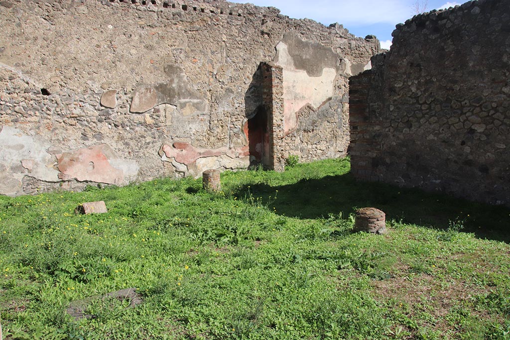 1.2.6 Pompeii. October 2024. 
Looking towards south end of east wall of peristyle, and doorway into triclinium. Photo courtesy of Klaus Heese.