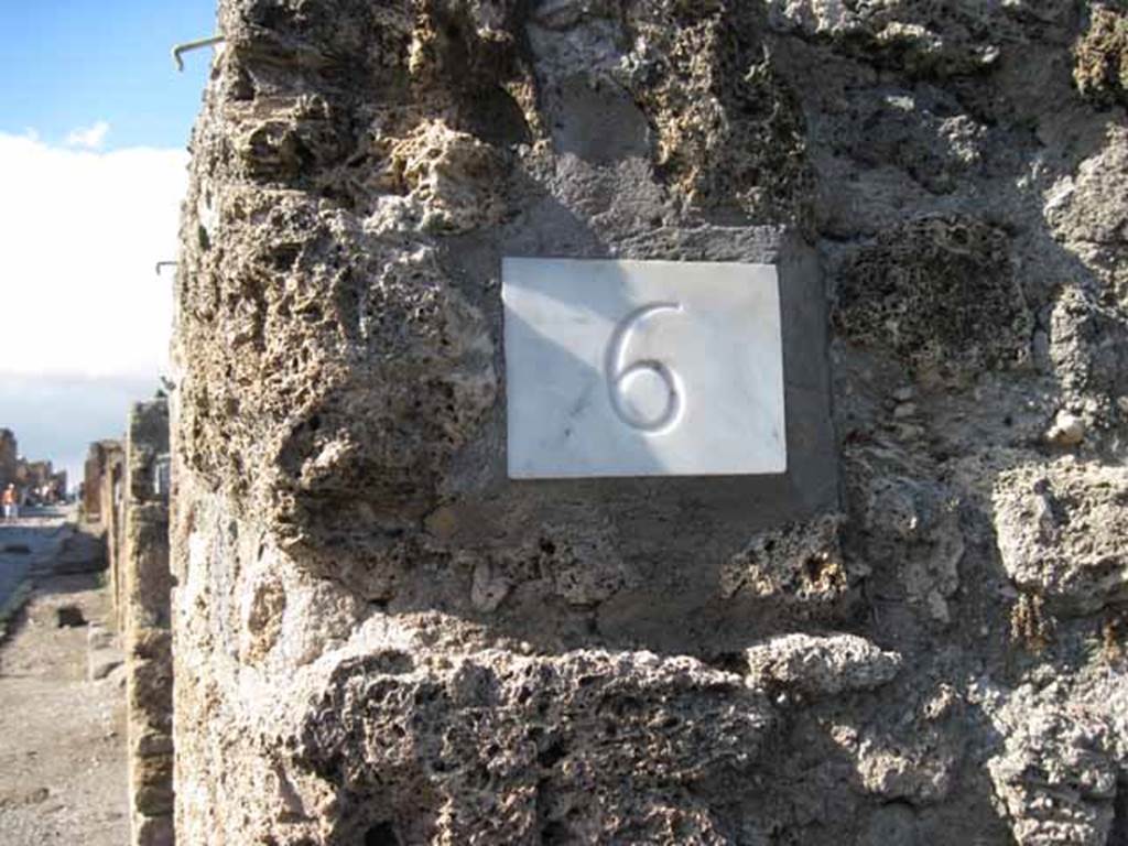 1.2.6 Pompeii. September 2010. ID number plate, and looking north along east side of Via Stabiana, from entrance. Photo courtesy of Drew Baker.