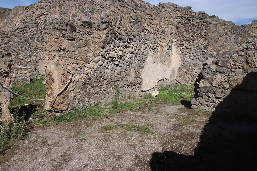 I.2.7 Pompeii. October 2024. Looking towards north wall of shop-room at east end, with doorway into I.2.8, on left.
On the right is the north wall of a rear room. Photo courtesy of Klaus Heese.
