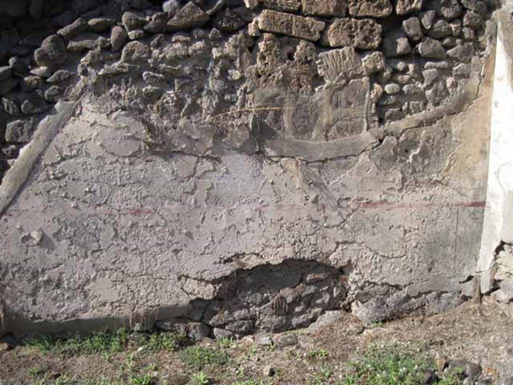 I.2.7 Pompeii. September 2010. North wall of rear room, with site of stairs on left. The wall (zoccolo and middle area) would have been painted white, panelled and compartmentalised by red painted lines (see corner area of north wall, on right). 
Photo courtesy of Drew Baker.