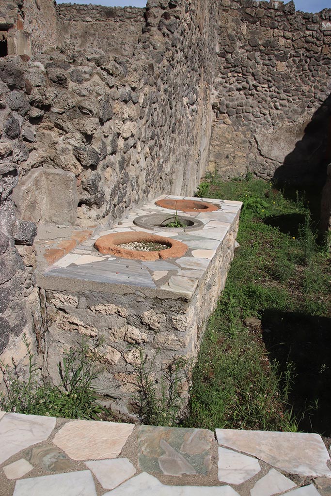 I.2.8 Pompeii. October 2024. 
Looking east along north wall into rear room. Photo courtesy of Klaus Heese.