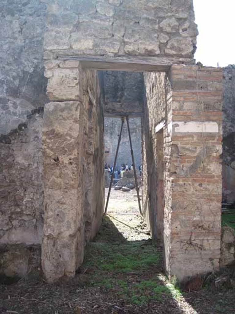 I.2.10 Pompeii. September 2010. Looking west. Doorway in west wall of garden area, into corridor leading to atrium. In the corridor on the left, is the entrance for the steps to the upper floor. In the corridor on the right, is the doorway into the triclinium with a window overlooking the garden. Photo courtesy of Drew Baker.