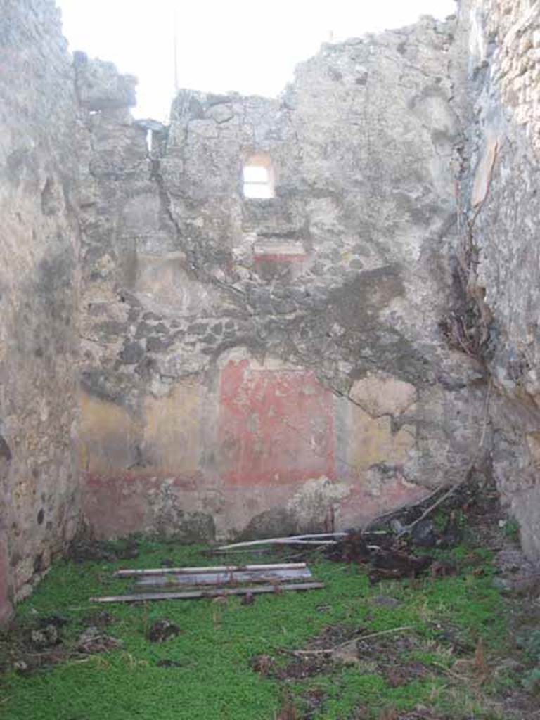 I.2.10 Pompeii. September 2010. West wall of triclinium. This wall appeared to have conserved the largest amount of the painted decoration. The middle zone of the wall had a central panel painted on a red background and also contained the remains of a painting that was probably already destroyed at the time of the excavation. The central panel was separated from the side yellow panels by means of a painted narrow green compartment. 
The remains of the stucco cornice can be seen below the window. Photo courtesy of Drew Baker.