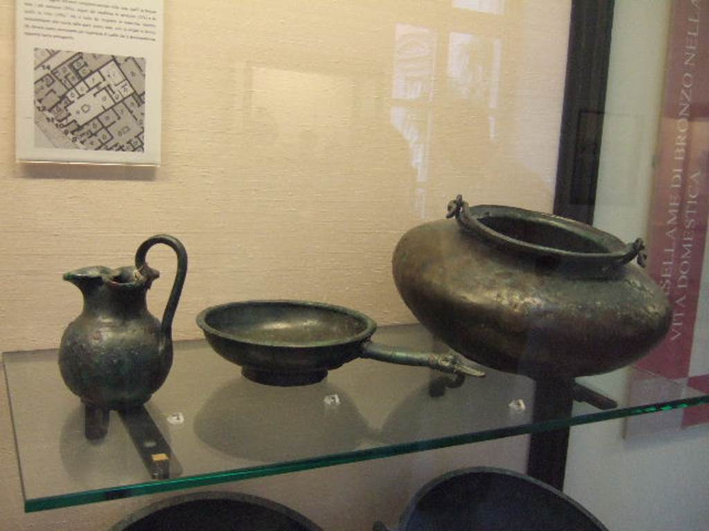 I.2.10 Pompeii.  Found in cubiculum. Bronze jug.  Now in Naples Archaeological Museum. Inventory number: 109816. Found in cubiculum. Bronze patera.  Now in Naples Archaeological Museum. Inventory number: 109818. Found in atrium.  Bronze cauldron.  Now in Naples Archaeological Museum. Inventory number: 111545.