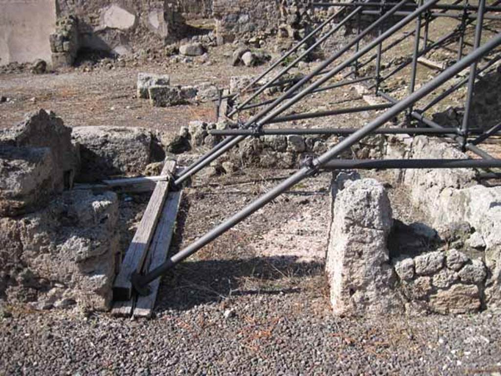 I.2.10 Pompeii. September 2010.  Looking north into doorway of remains of cubiculum, in north-west corner of atrium. At the rear is I.2.11/12/13/14. Photo courtesy of Drew Baker.
