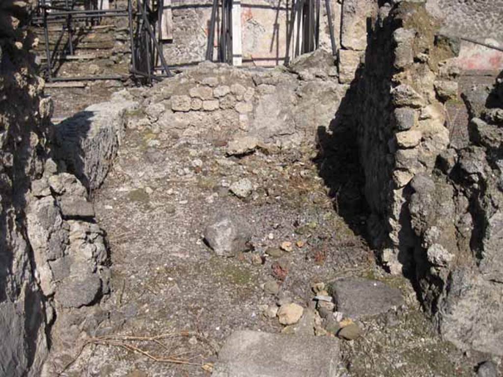I.2.11 Pompeii. September 2010. Looking east into small rear room of the bar. Photo courtesy of Drew Baker.
According to Garcia y Garcia, originally there was an o.m.a.b (ostium muratum ab antiquo) in the south wall of the small rear room, leading to I.2.10. See Garcia y Garcia, L., 2006. Danni di guerra a Pompei. Rome: L’Erma di Bretschneider. (p.37)