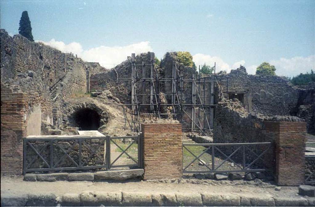 I.2.12 Pompeii. July 2011. Looking east to entrance doorway (on right) from Via Stabiana. Photo courtesy of Rick Bauer.
Warscher described this, quoting Fiorelli, as  “I.2.12/13 – due taberne aventi comunicazione tra loro.  Il podio è rivestito di marmi.  Qui l’insula è delimitata dalla via secunda, sulla quale si aprono gl’ingressi di altre abitazioni”.
See Warscher T., 1935. Codex Topographicus Pompeianus: Regio I.2. Rome: DAIR.
(translation: "I. 2.12/13 - two workshops having communication between them.  The podium was covered with marble.   Here the insula is bounded by via secunda, on which opens the entrances of other dwellings.")