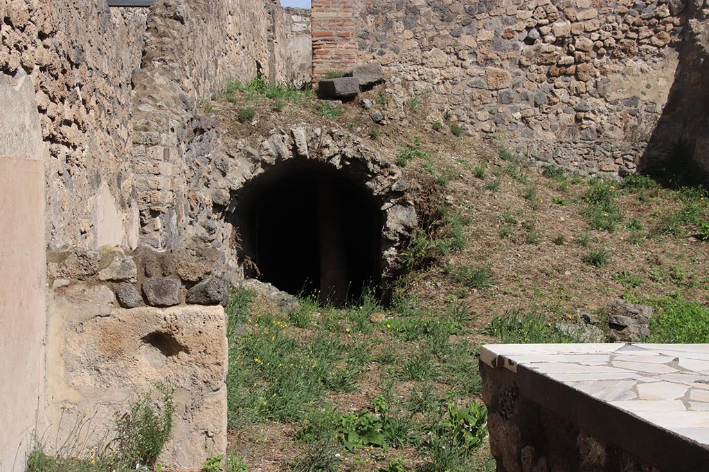 I.2.13 Pompeii. October 2024. North-east corner of bar-room, lower front.
Looking east towards site of small storeroom or cupboard, bombed in 1943, centre of photo. Photo courtesy of Klaus Heese.