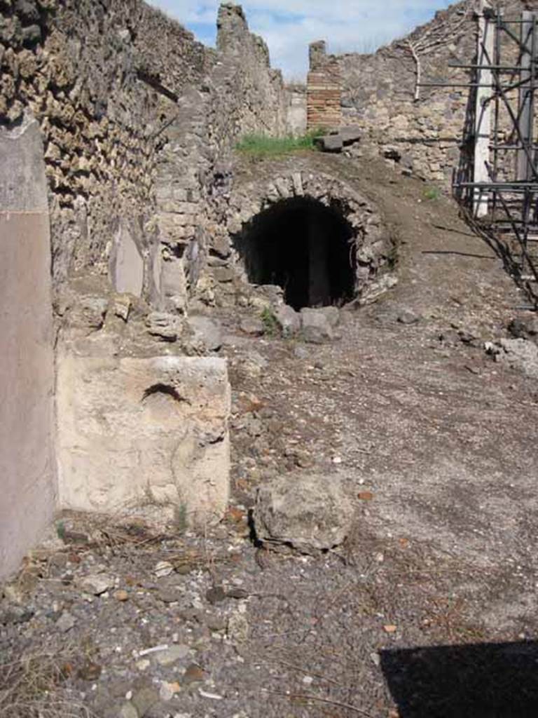 I.2.13 Pompeii. September 2010. North-east corner of bar-room, at front.
Looking east towards site of small storeroom or cupboard, bombed in 1943, centre of photo. Photo courtesy of Drew Baker.