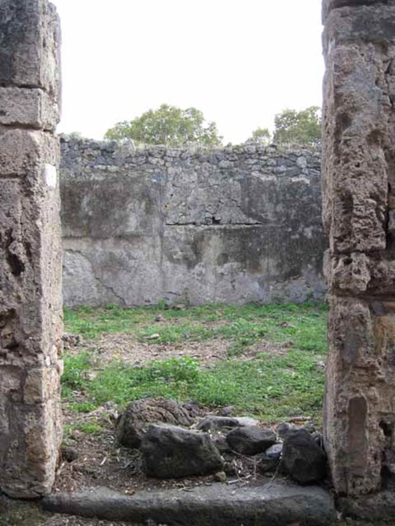 I.2.15 Pompeii. September 2010. Looking south to entrance doorway.
Photo courtesy of Drew Baker.
According to Warscher, quoting Fiorelli, she wrote – “I.2.15, una casa che apparteneva a persona di umile condizione e che ricorda la casa primitiva di Pompei: consiste dell’atrio “a”, due cubicoli e di una fauce che menava alla cucina, alla stalla, ad’una apotheca, alla latrina, ed a una gradinata di fabbrica per le stanze superiori”.
See Warscher T., 1935. Codex Topographicus Pompeianus: Regio I.2. Rome: DAIR.
(translation: "I. 2.15, a house that belonged to a person of humble condition and reminiscent of primitive houses of Pompeii: consisting of an atrium “a”, two cubiculae, and a corridor that led to the kitchen, to the stable, and to a storeroom, to the latrine, and to a masonry staircase to the upper rooms.”)